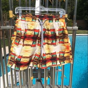 Spenglish tropical swim trunks.